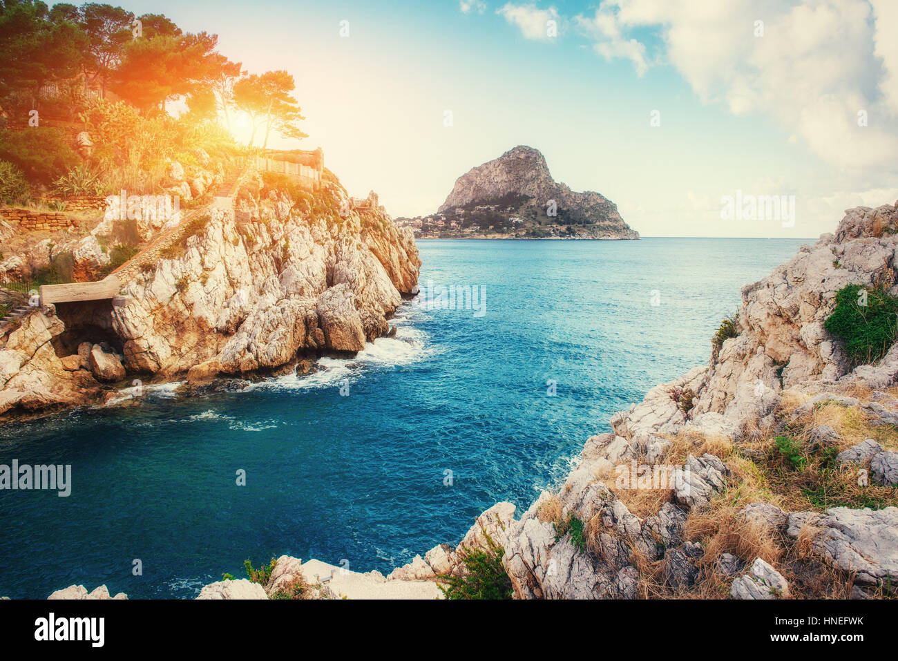 Sunset over the sea with rocks in Italy Stock Photo