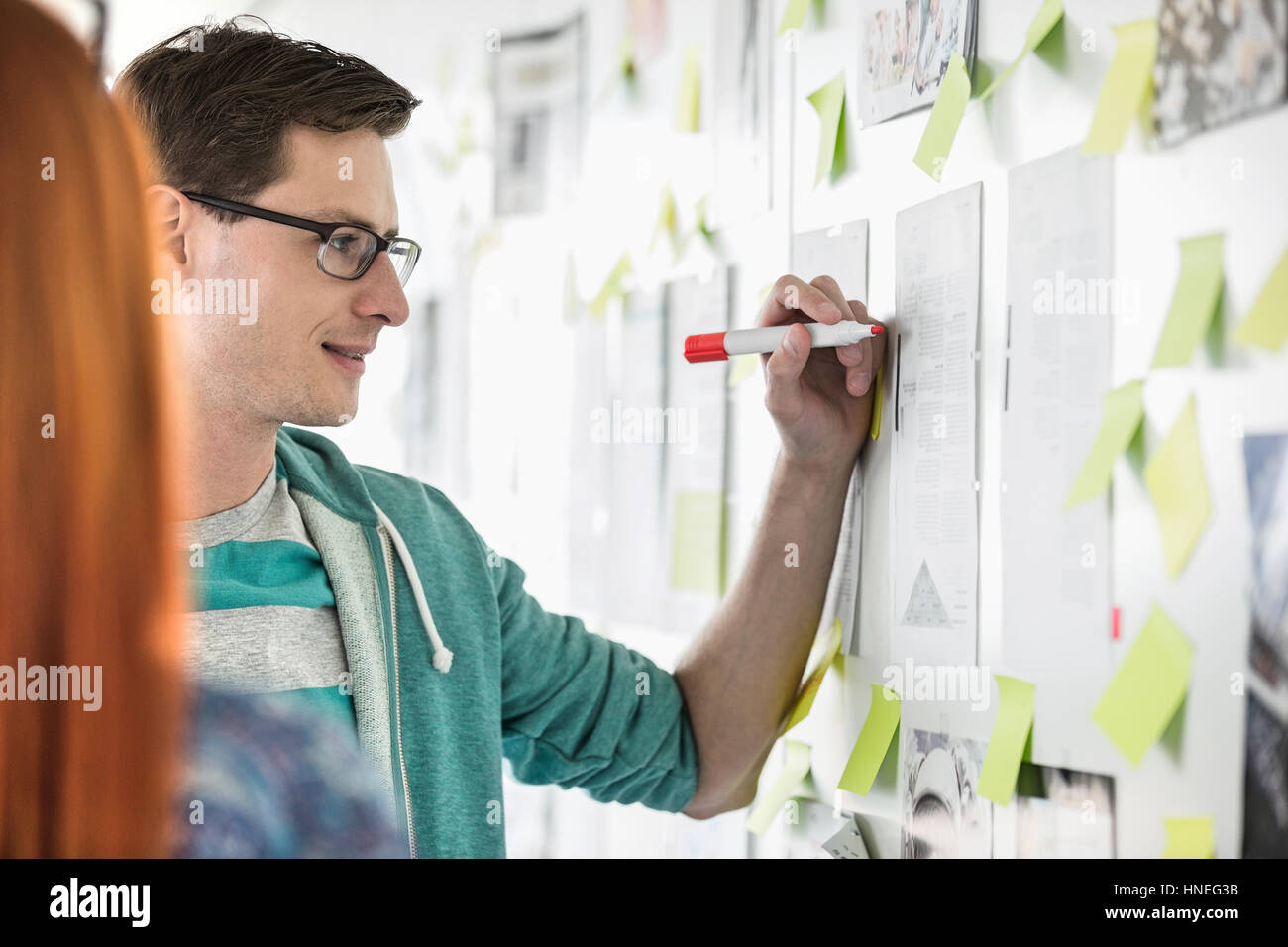 Creative businessman writing notes on paper in office Stock Photo - Alamy