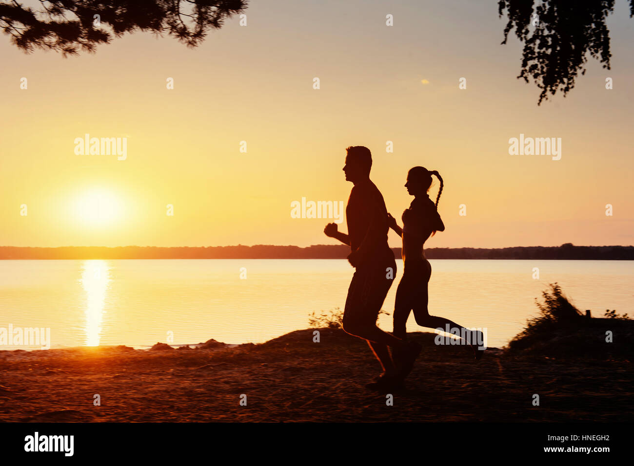 couple on the bike at sunset Stock Photo - Alamy