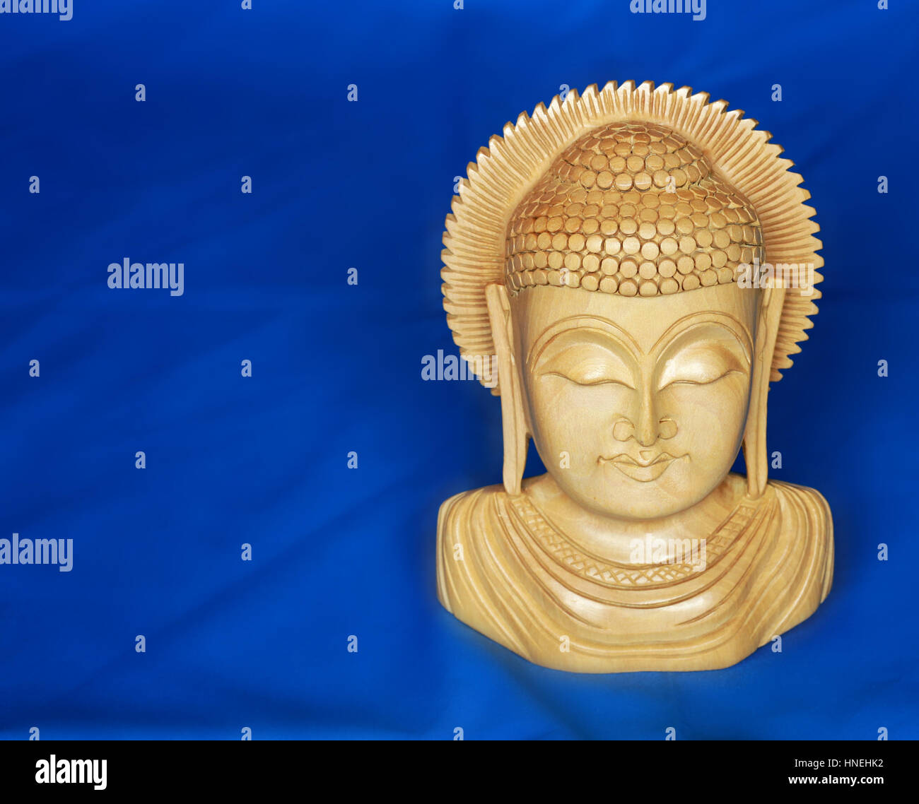 Sandalwood Buddha on blue background Stock Photo