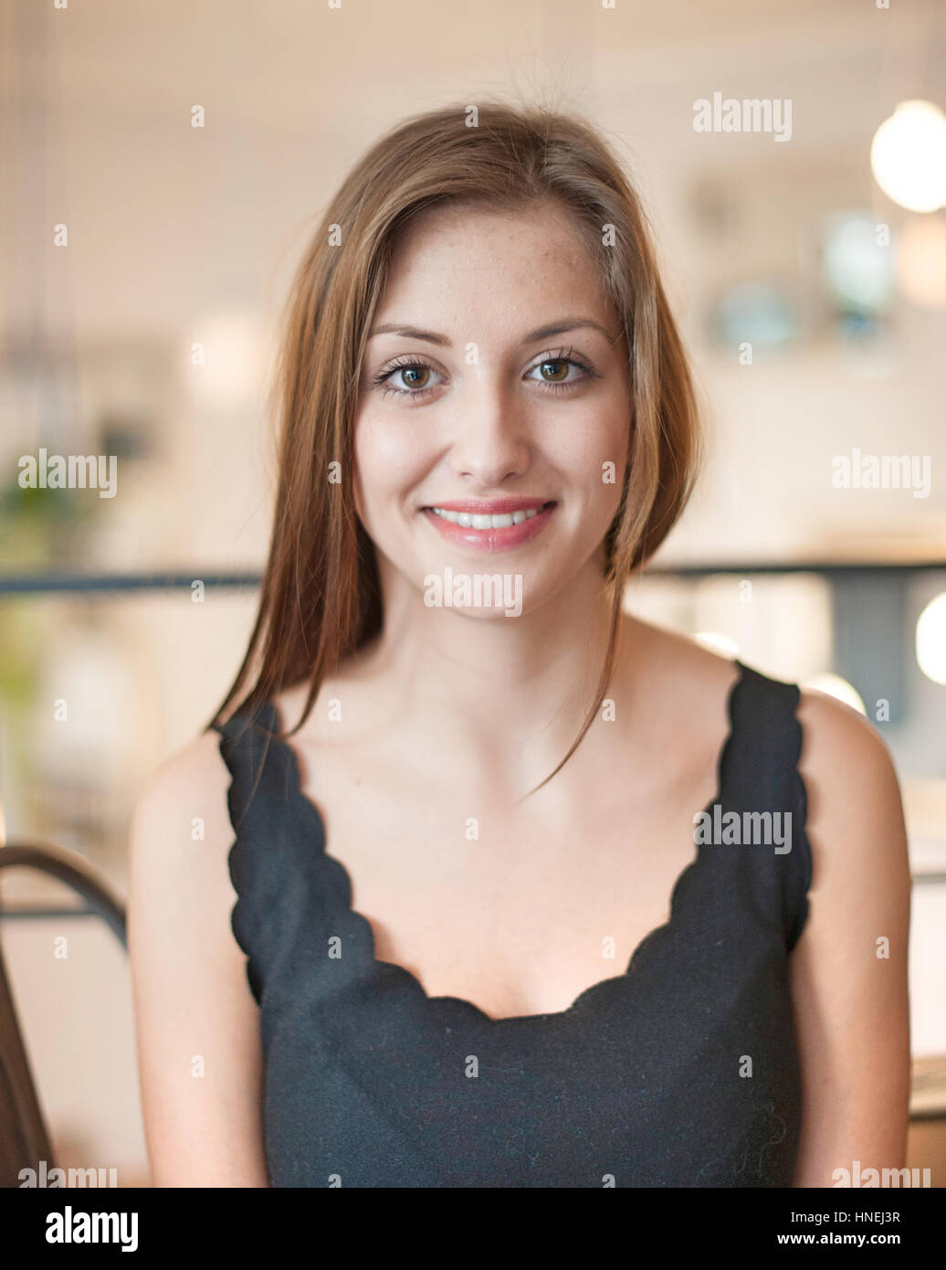 Portrait of beautiful young woman smiling at cafe Stock Photo - Alamy