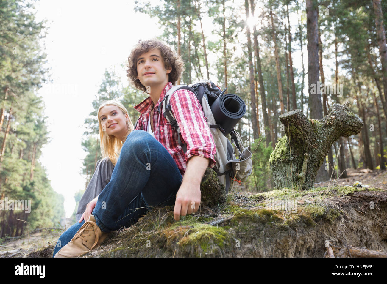 Young hiking couple relaxing in forest Stock Photo