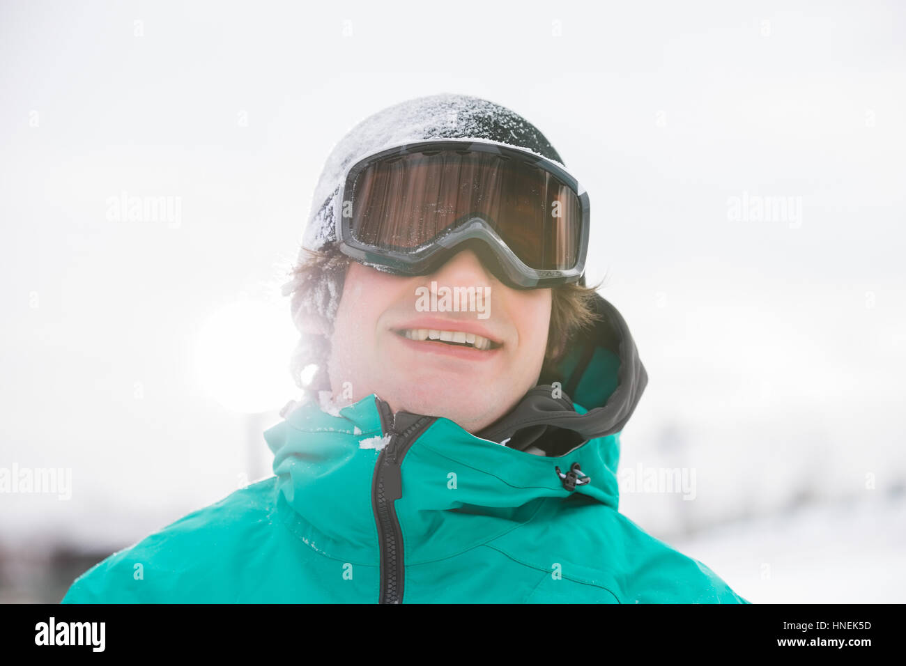 Handsome young man wearing ski goggles outdoors Stock Photo