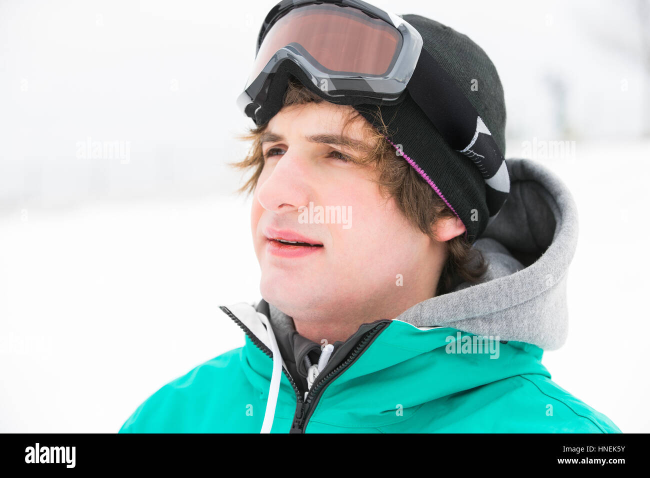 Young man wearing ski goggles outdoors Stock Photo