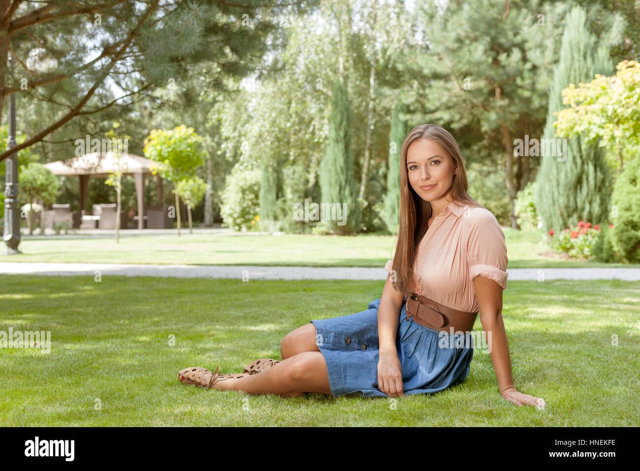 Full length portrait of beautiful young woman relaxing in park Stock ...