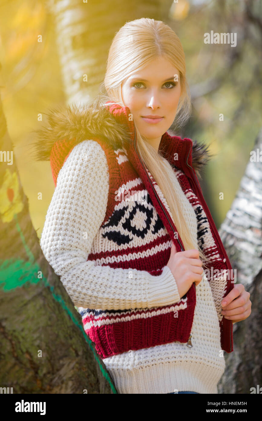 Portrait of beautiful woman in warm clothing standing in park Stock Photo
