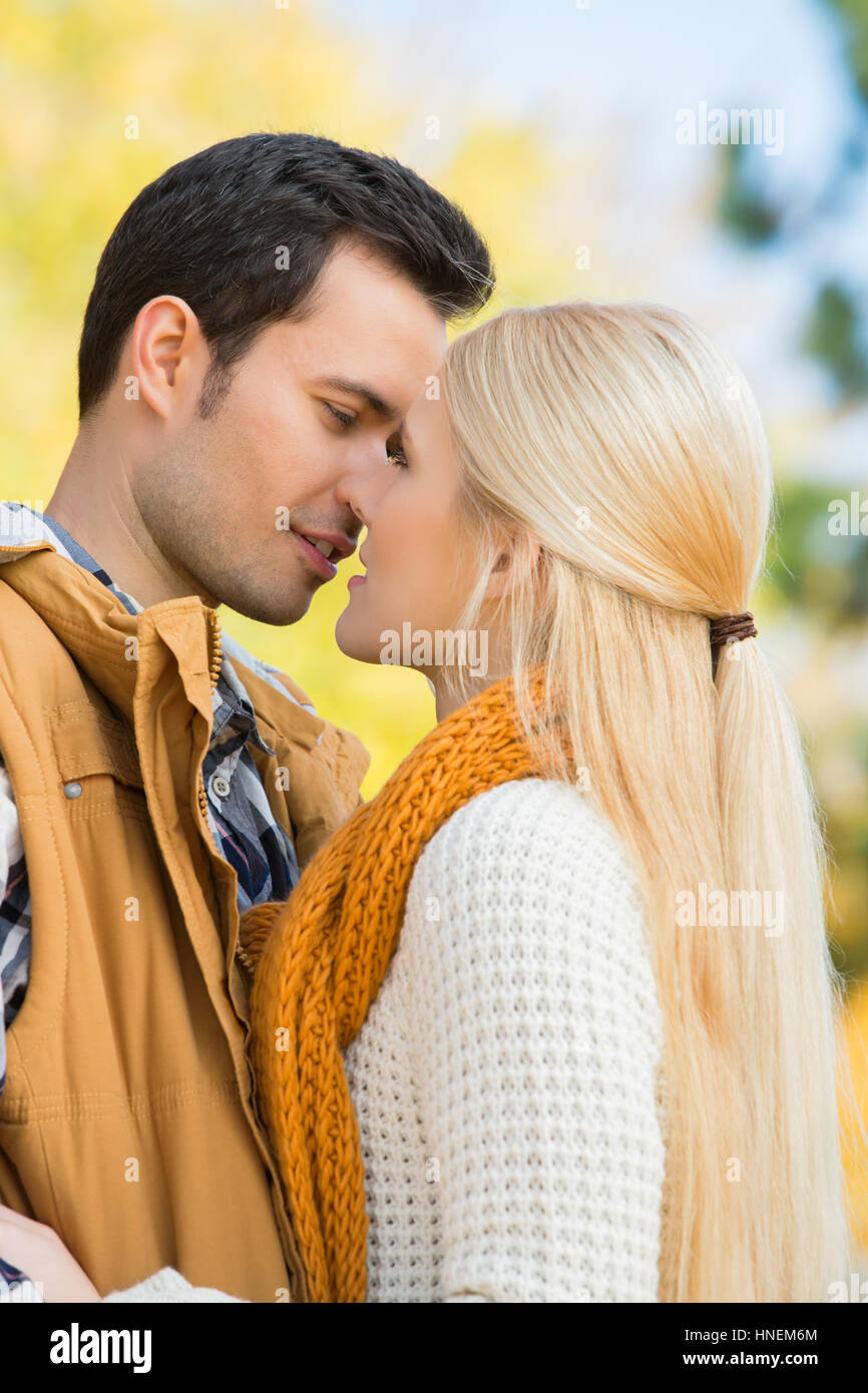 Passionate couple kissing in park Stock Photo