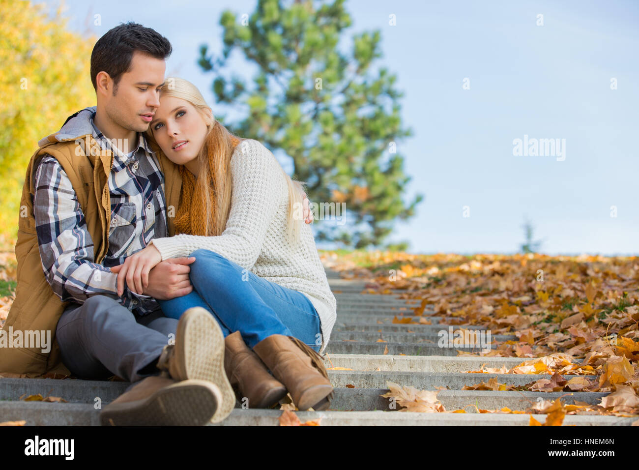 Loving couple sitting on park steps Stock Photo