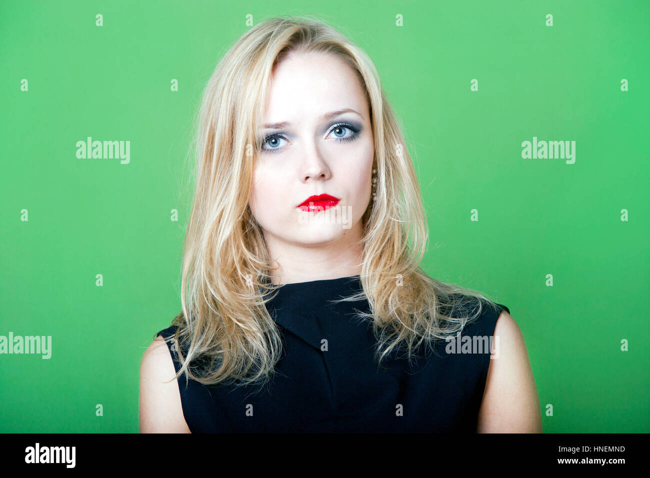 Blonde woman on green background Stock Photo - Alamy