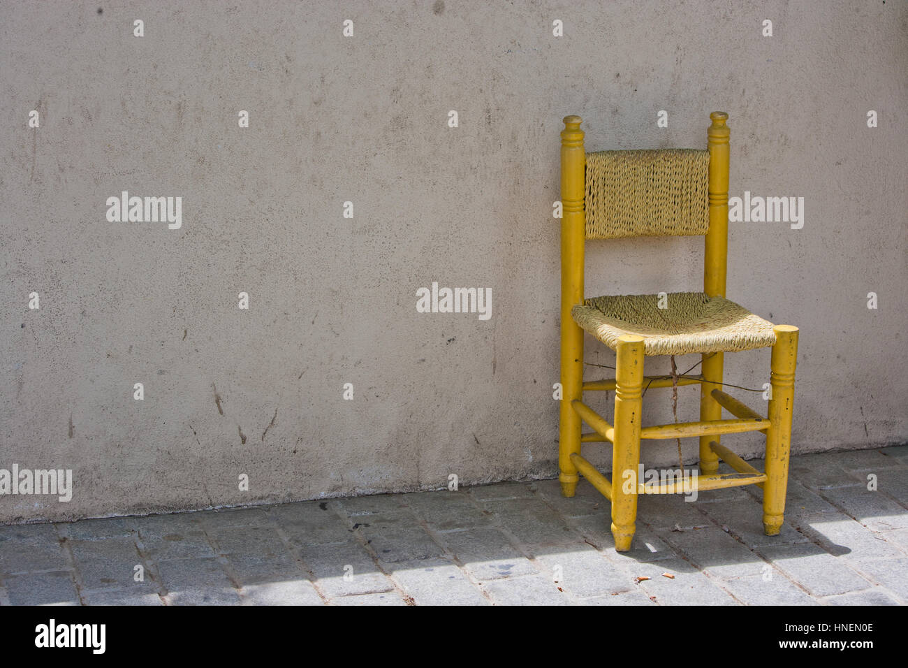 Yellow Chair against Brick Wall in Istanbul Stock Photo