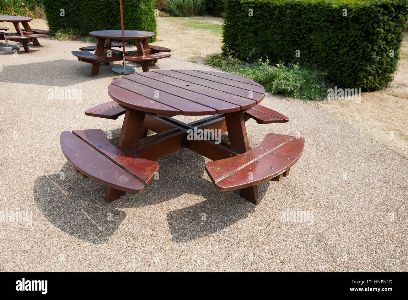 Wooden picnic tables in park Stock Photo Alamy
