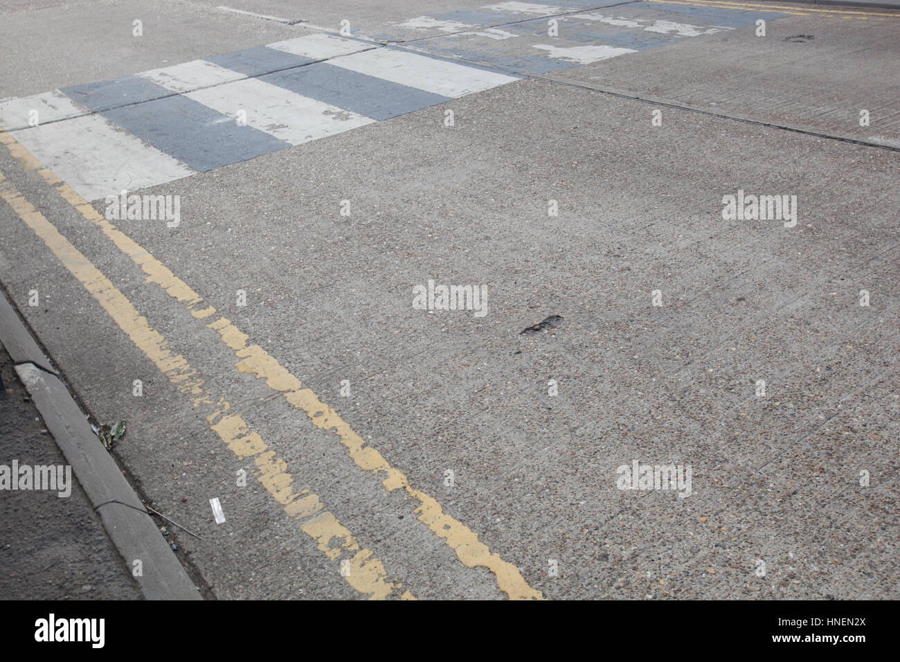 Close-Up of double yellow line on road and Zebra crossing Stock Photo