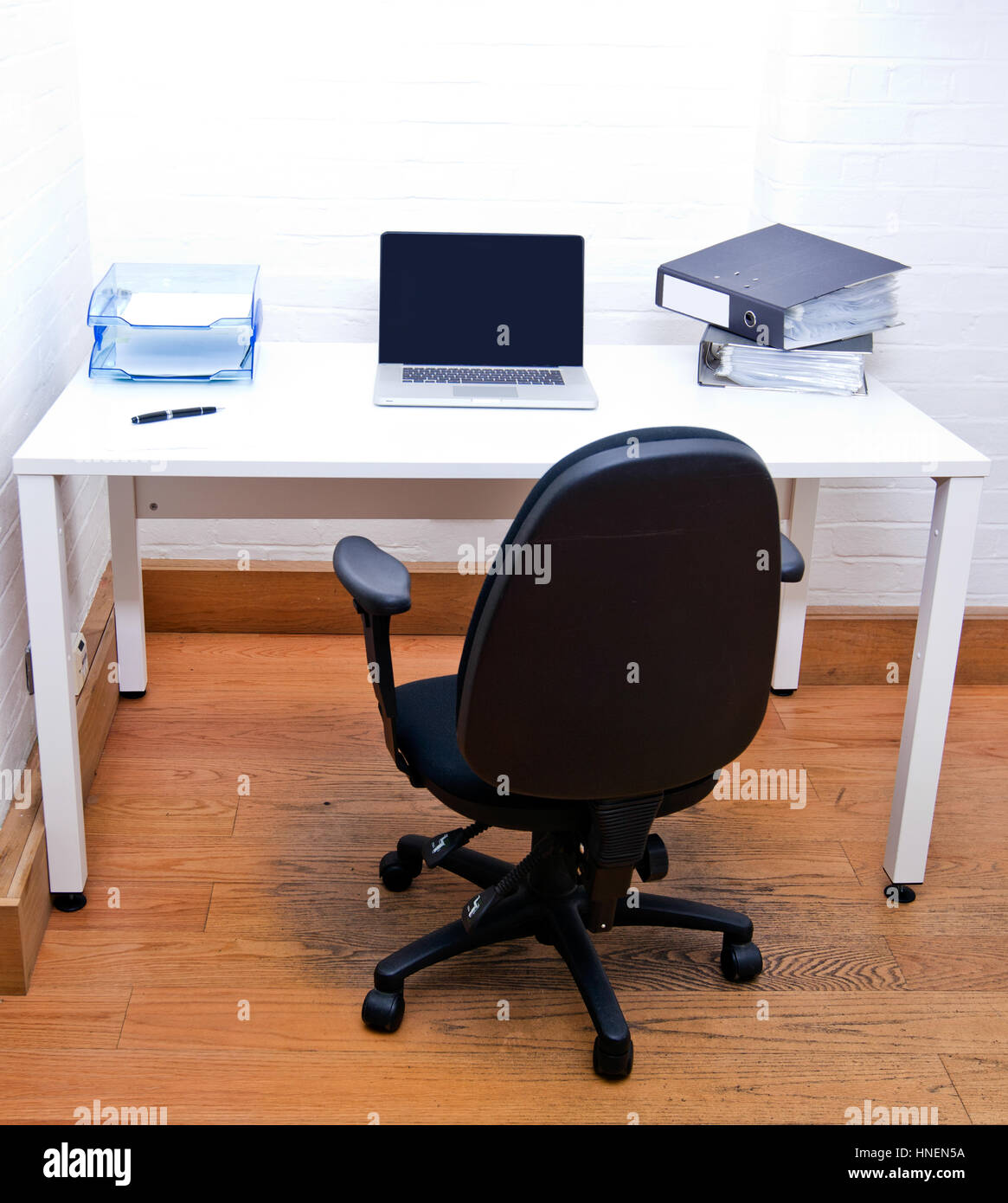 Empty office chair with laptop on desk Stock Photo