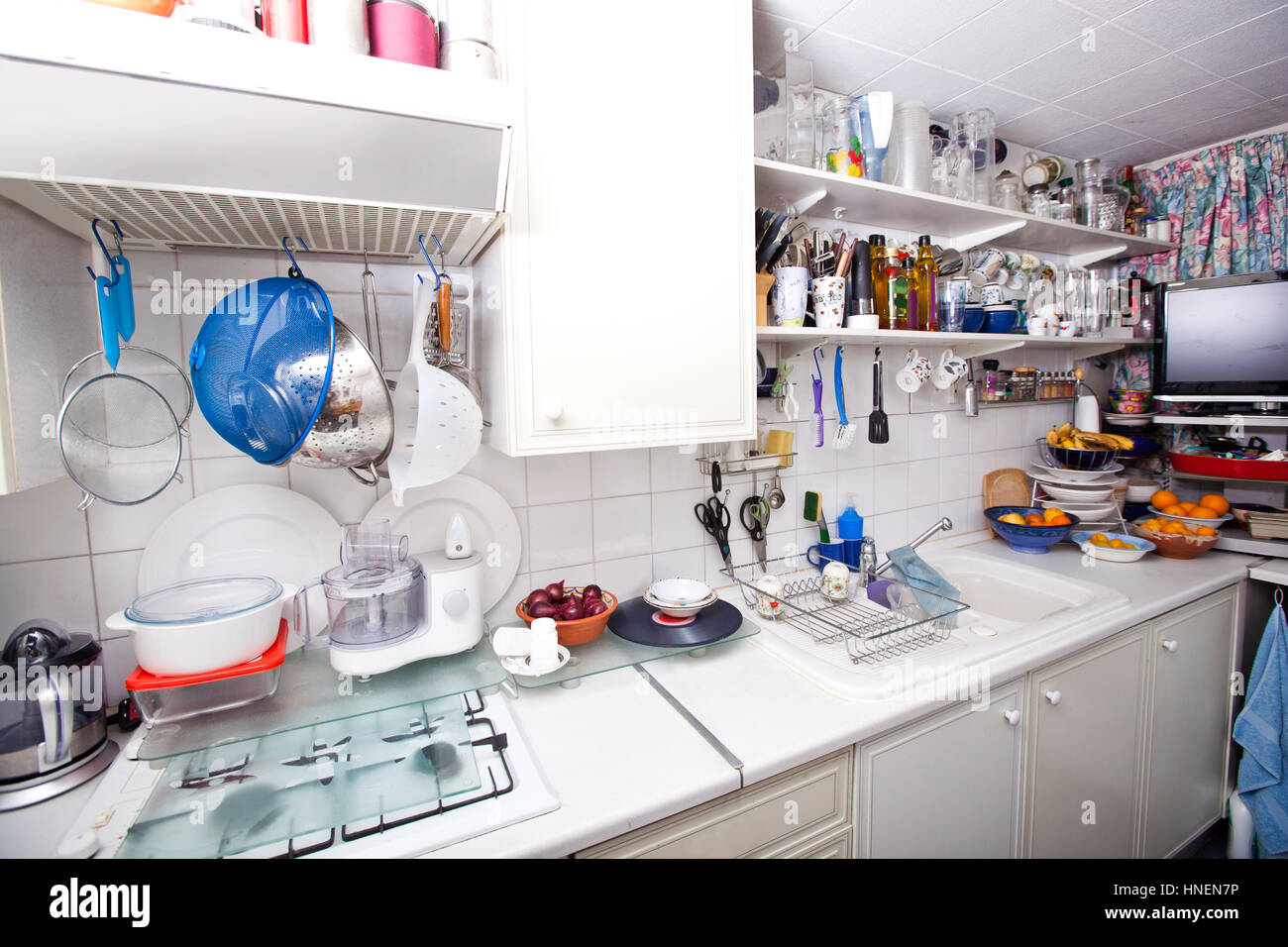 Interior of domestic kitchen with utensils and shelves Stock Photo