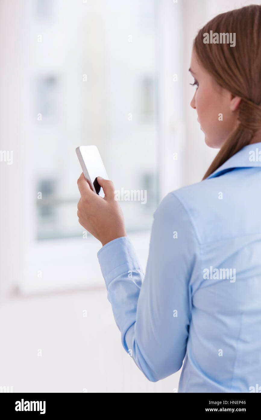 Female rear view mobile texting hi-res stock photography and images - Alamy