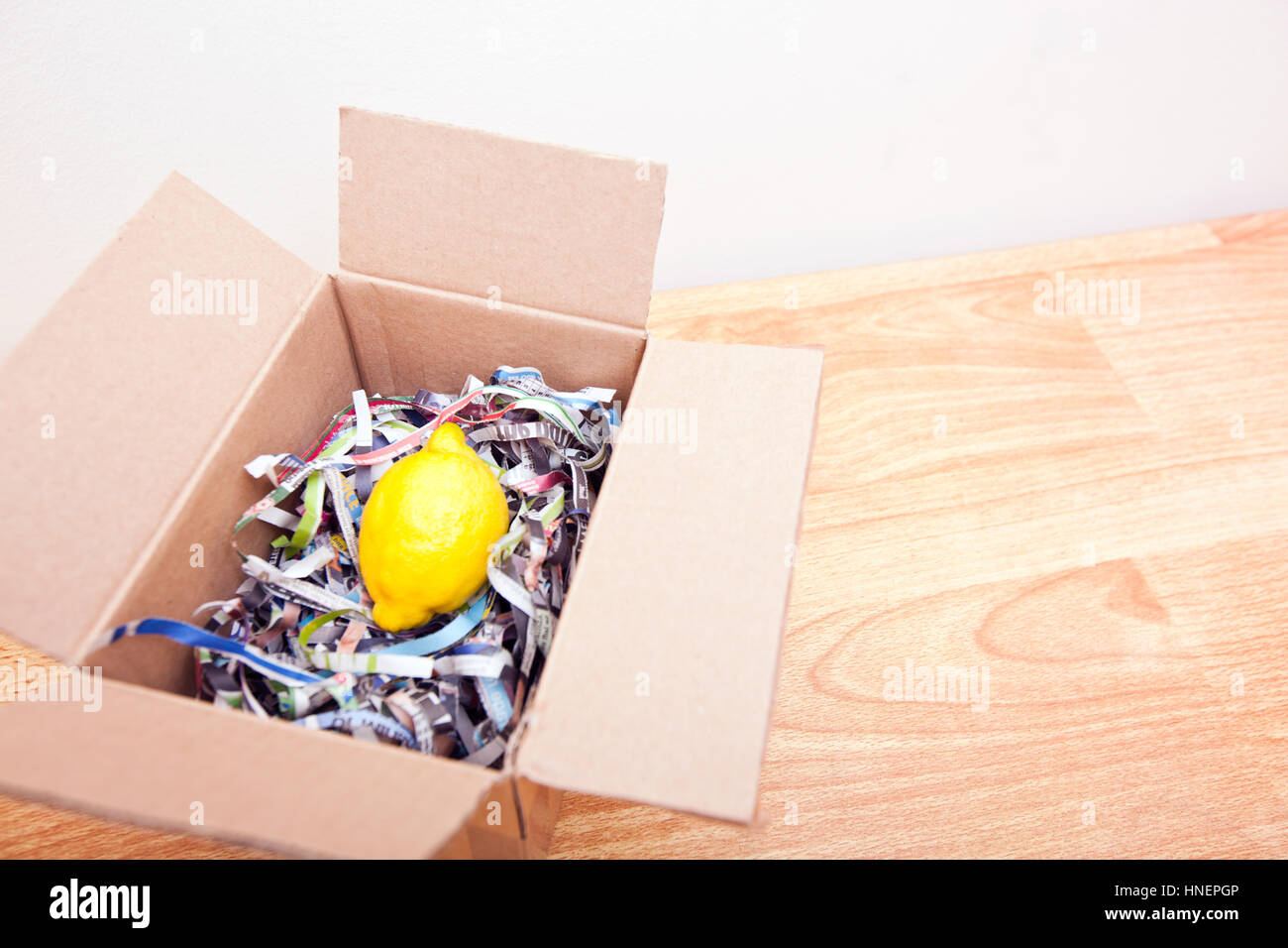 Lemon wrapped up in a box Stock Photo