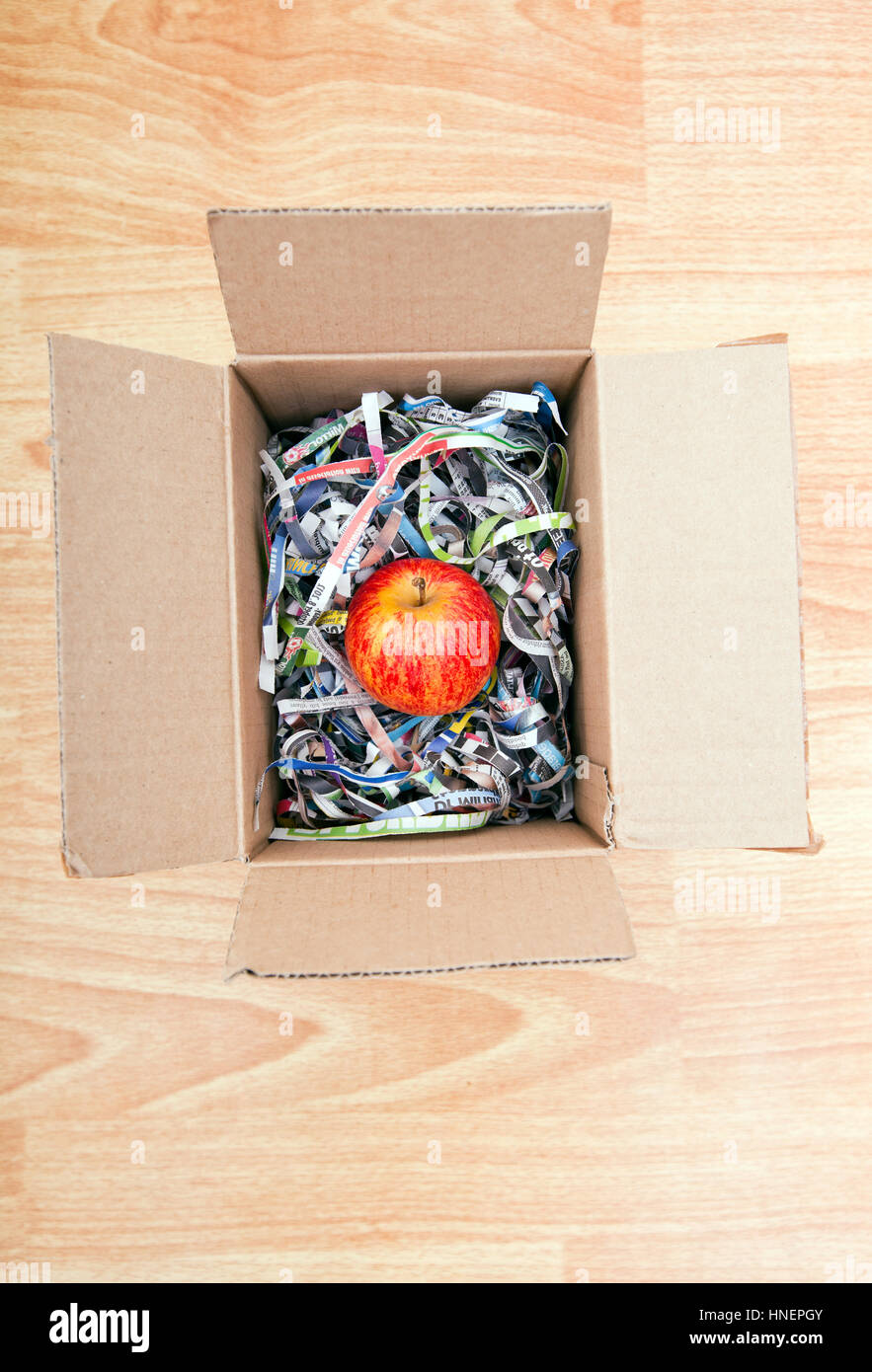 Apple wrapped up in a box Stock Photo