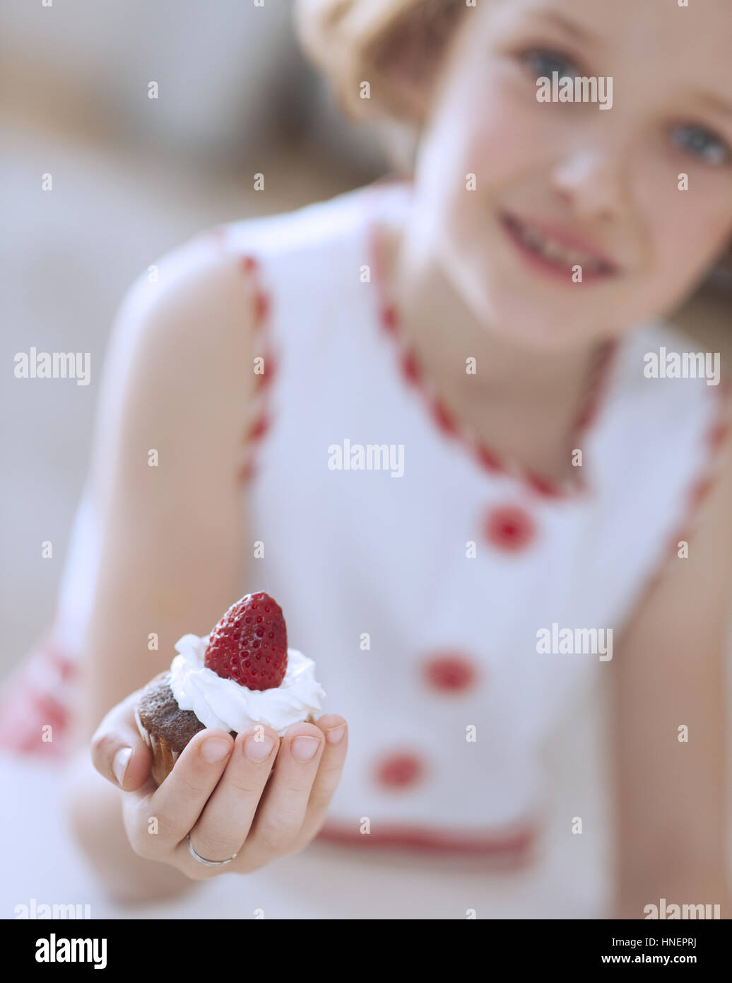 Young girl holding cup cake Stock Photo