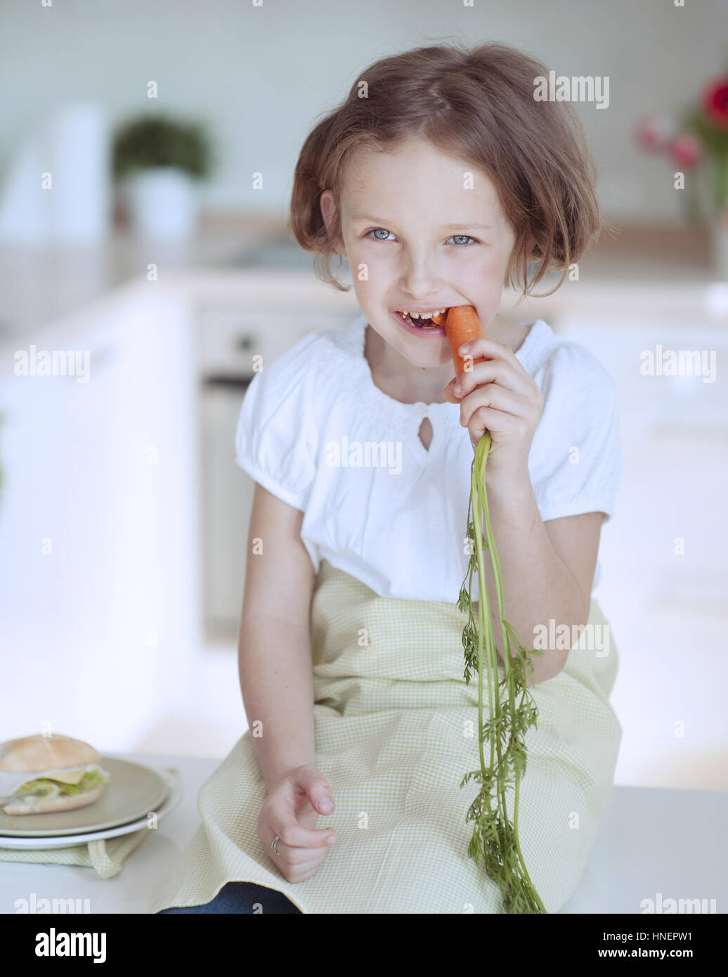 Young girl eating carrot Stock Photo