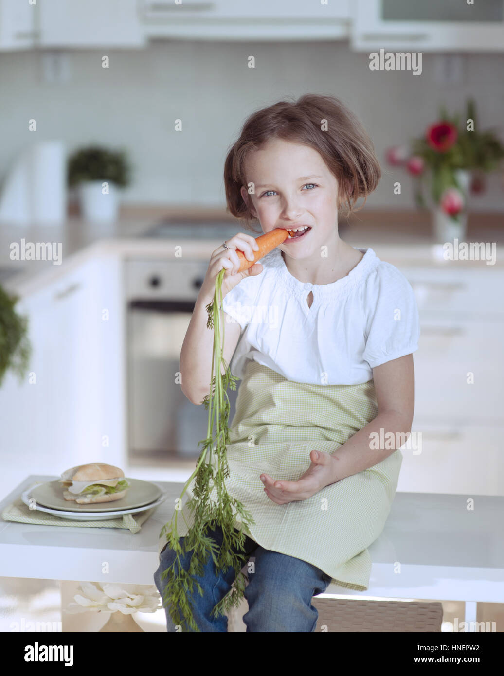 Young girl eating carrot Stock Photo