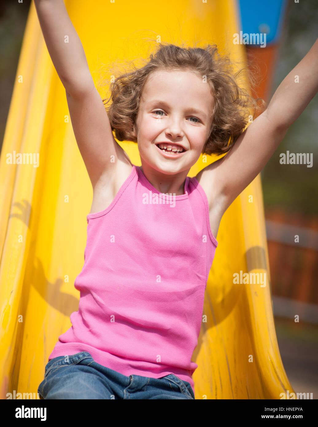 Close-up view of young girl on slide in playground Stock Photo - Alamy