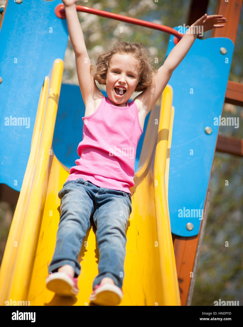 Close-up view of young girl on slide in playground Stock Photo - Alamy