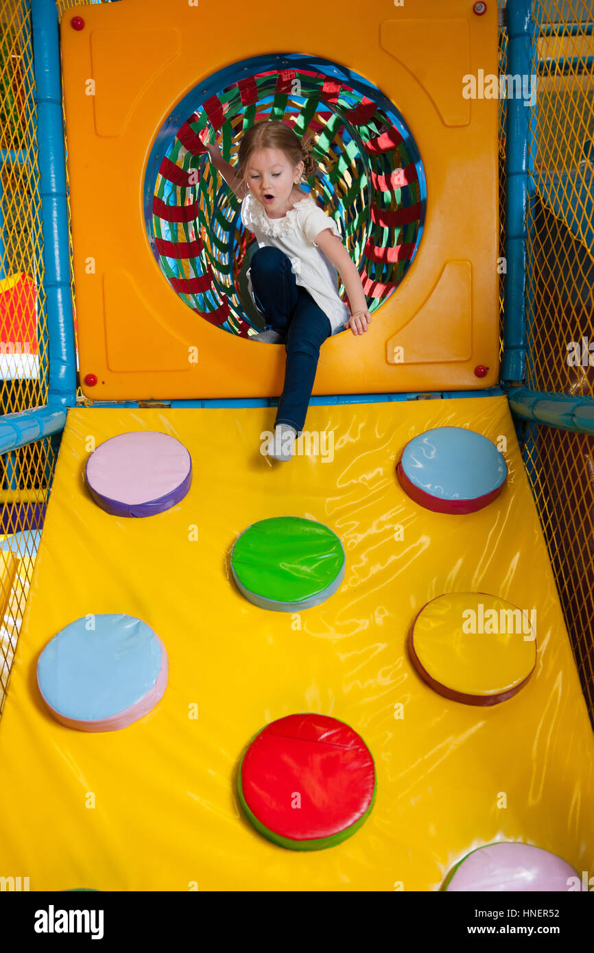 Young girl climbing down ramp in soft play centre Stock Photo - Alamy