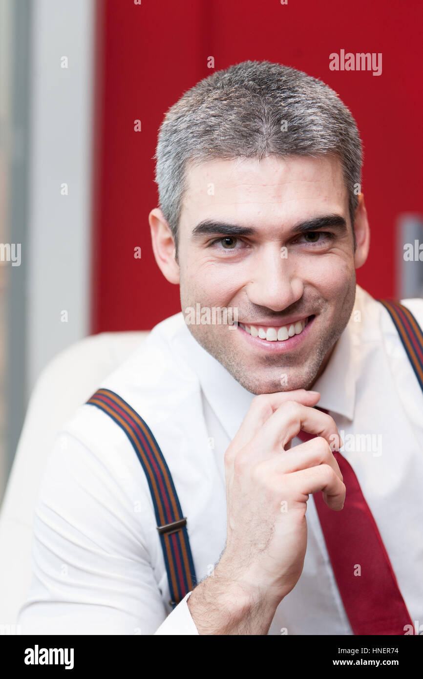 Close-up of businessman smiling at camera Stock Photo - Alamy