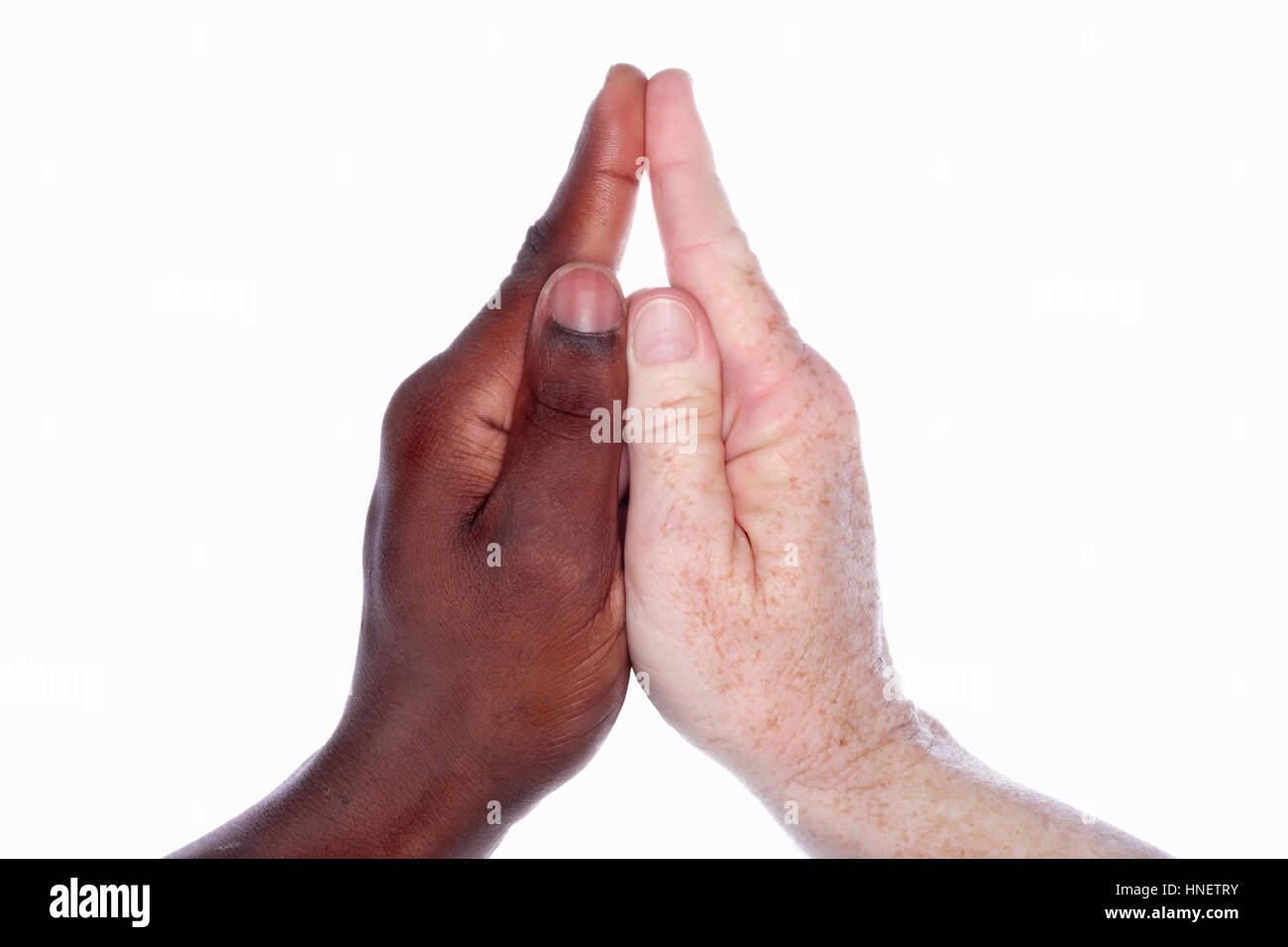 two diverse people's hands form a church Stock Photo