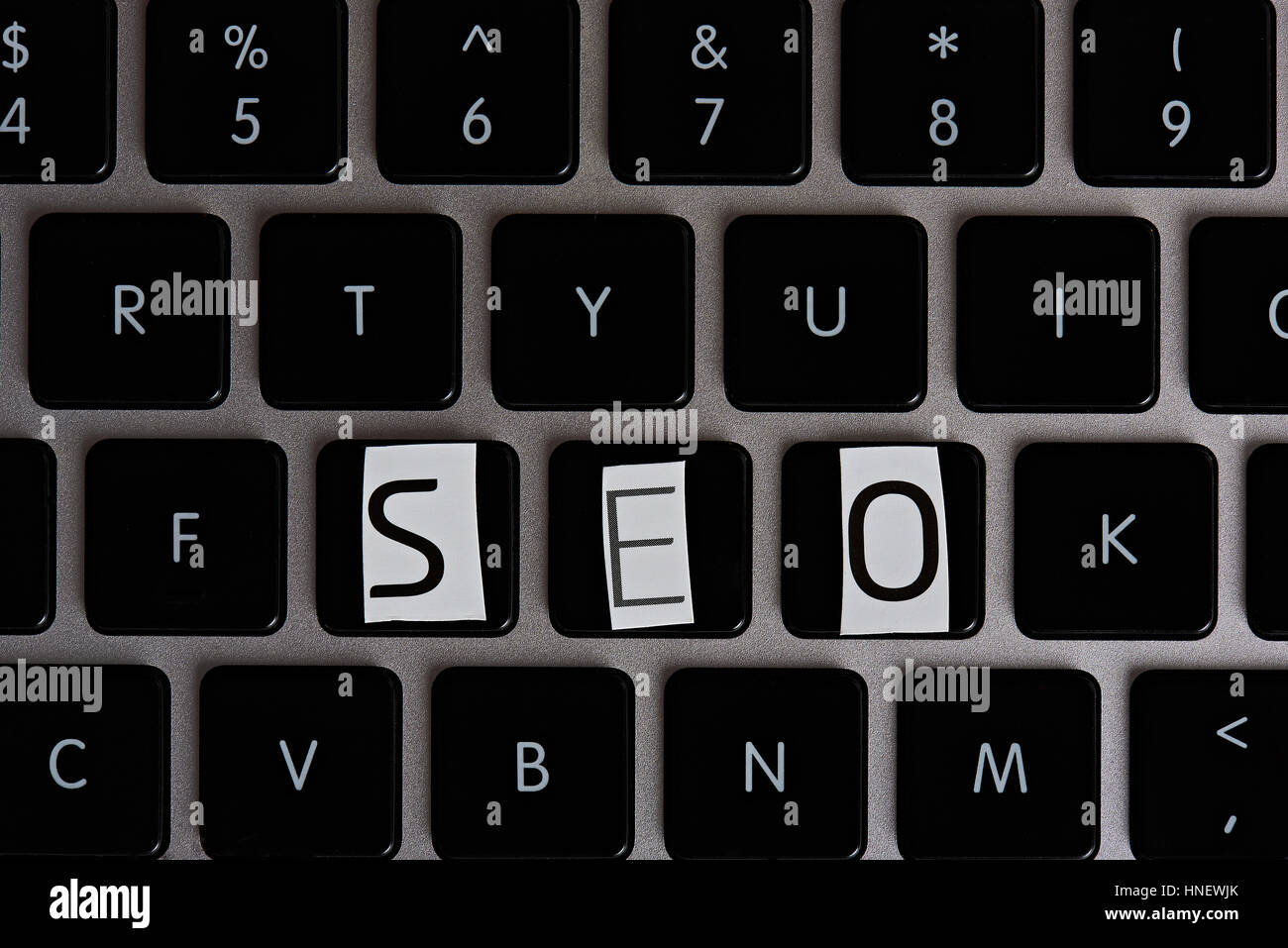 SEO word on keyboard from cutout magazine letters Stock Photo