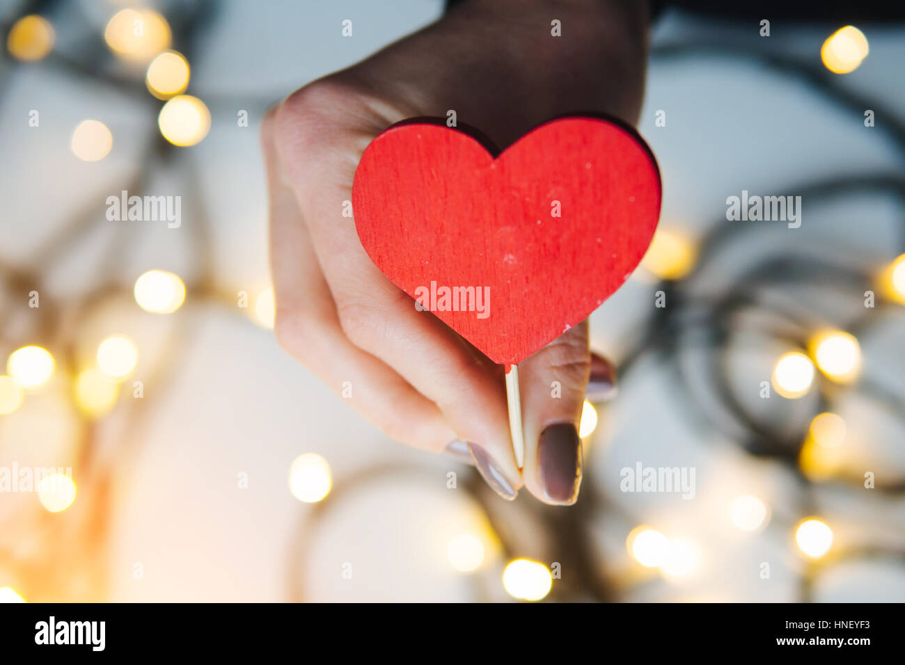 girl holding a red heart in the hands Stock Photo - Alamy