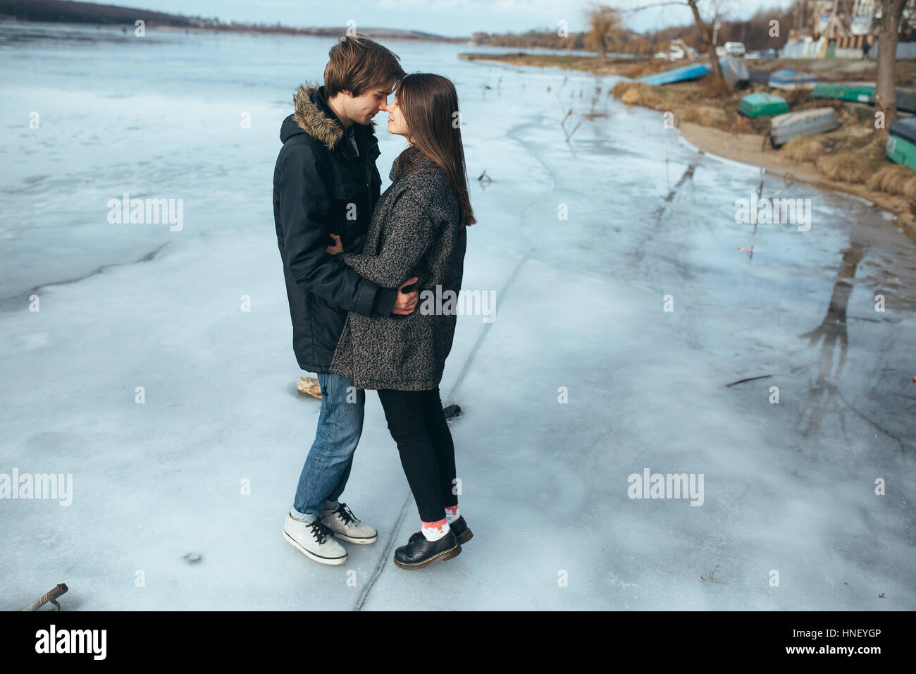 young beautiful couple on the ice of a frozen lake Stock Photo - Alamy
