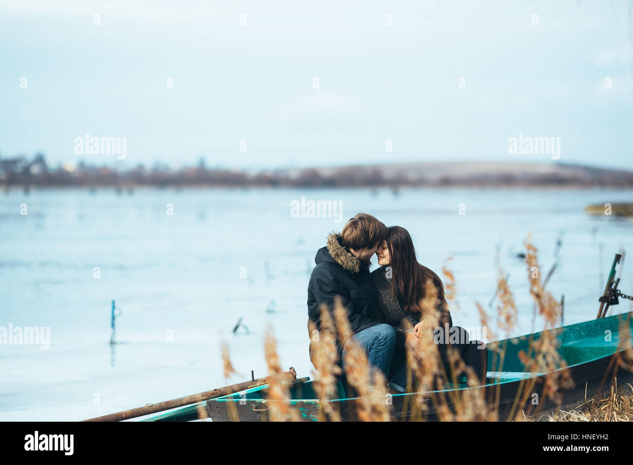 young beautiful couple on the ice of a frozen lake Stock Photo - Alamy