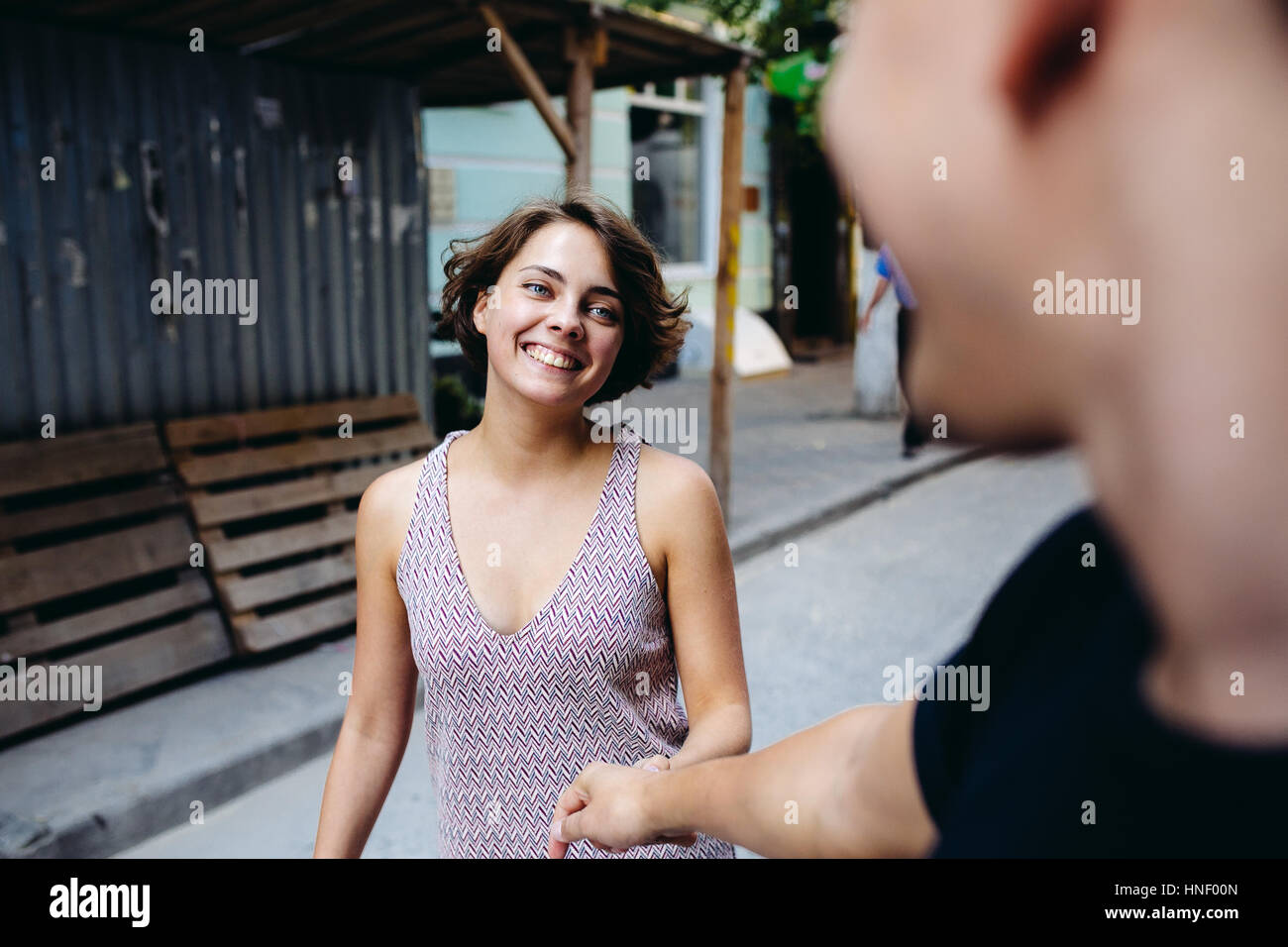 couple walking on the street holding hands Stock Photo - Alamy