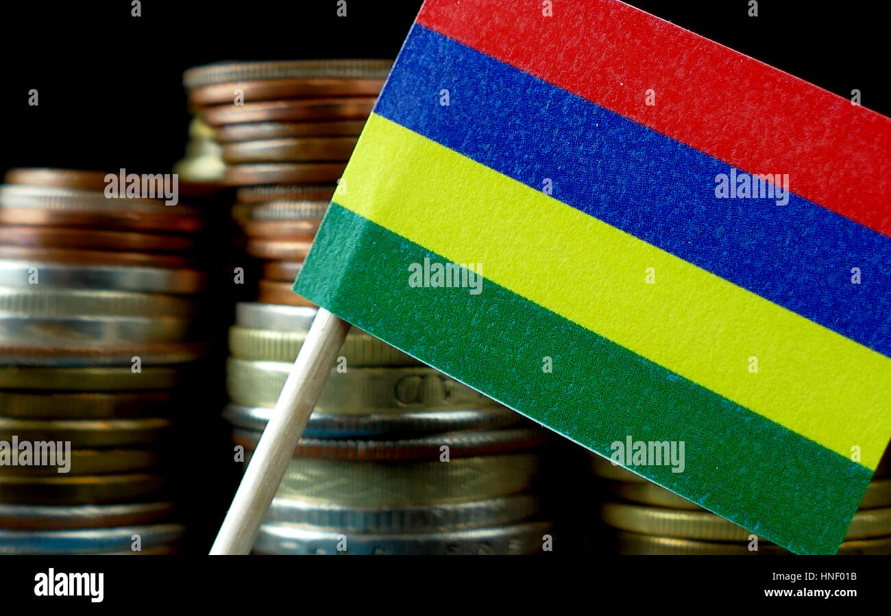 Mauritius flag waving with stack of money coins macro Stock Photo