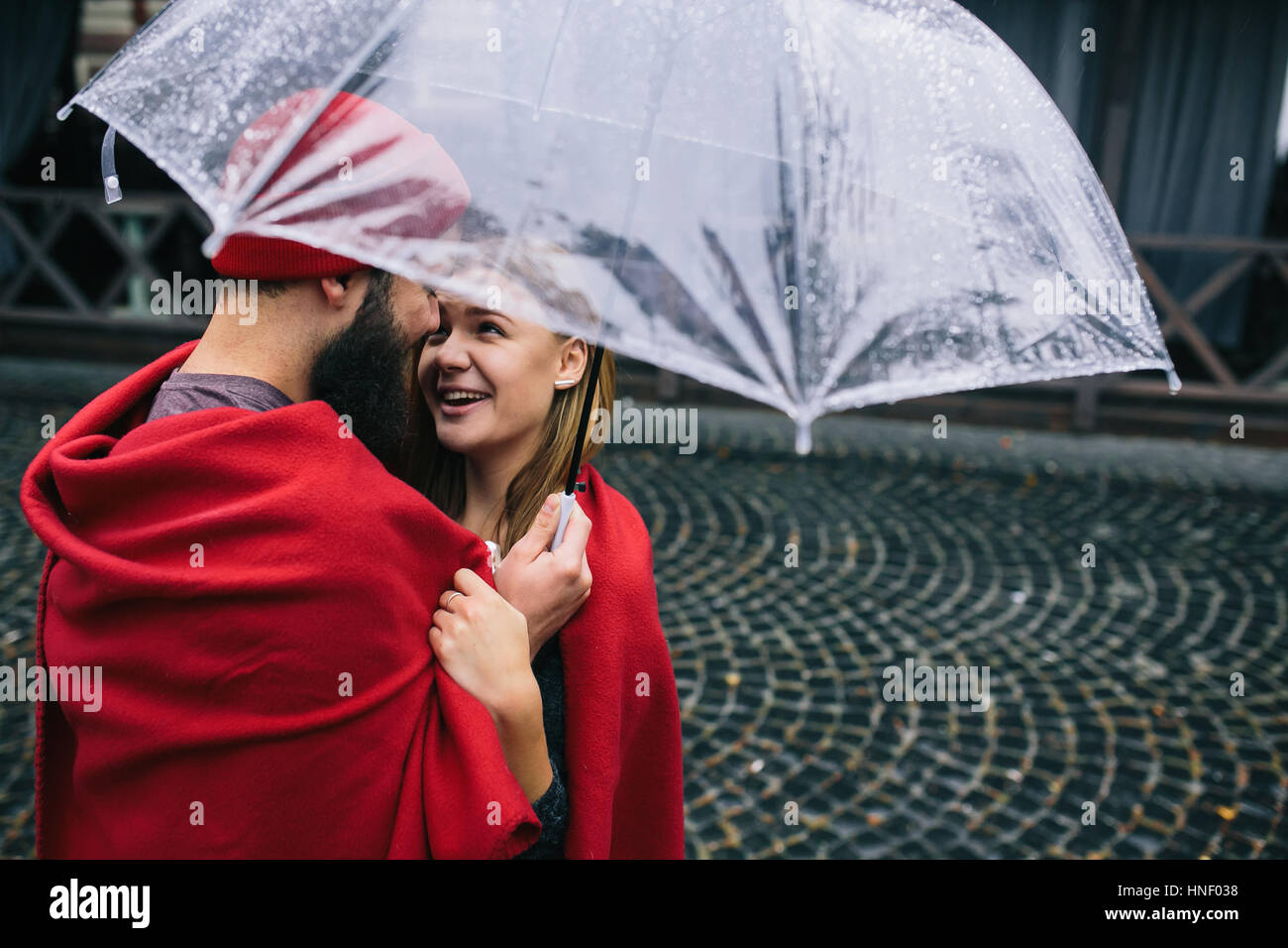 guy and girl under an umbrella Stock Photo