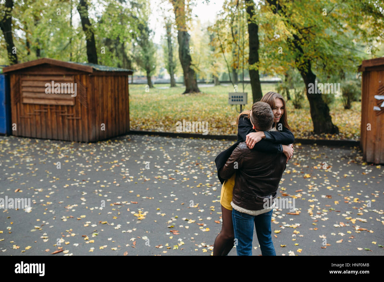 attractive happy couple walking in autumn park Stock Photo - Alamy