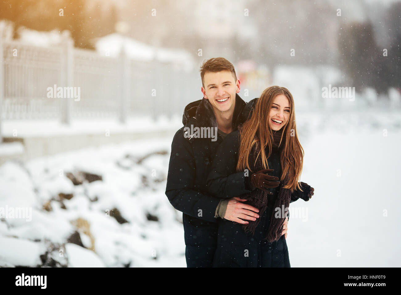 couple posing in a snowy park Stock Photo - Alamy