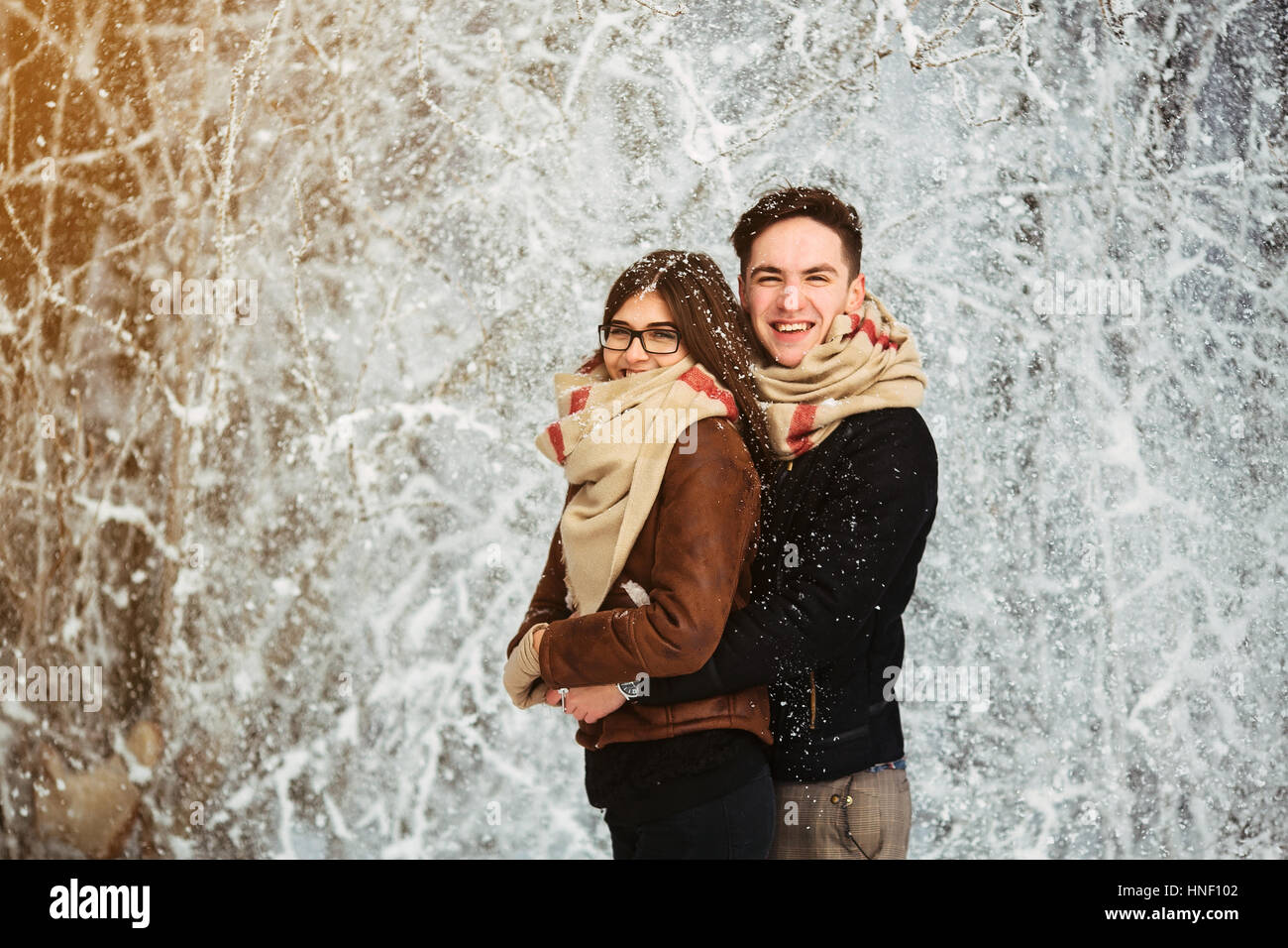 Happy couple in snow park Stock Photo - Alamy