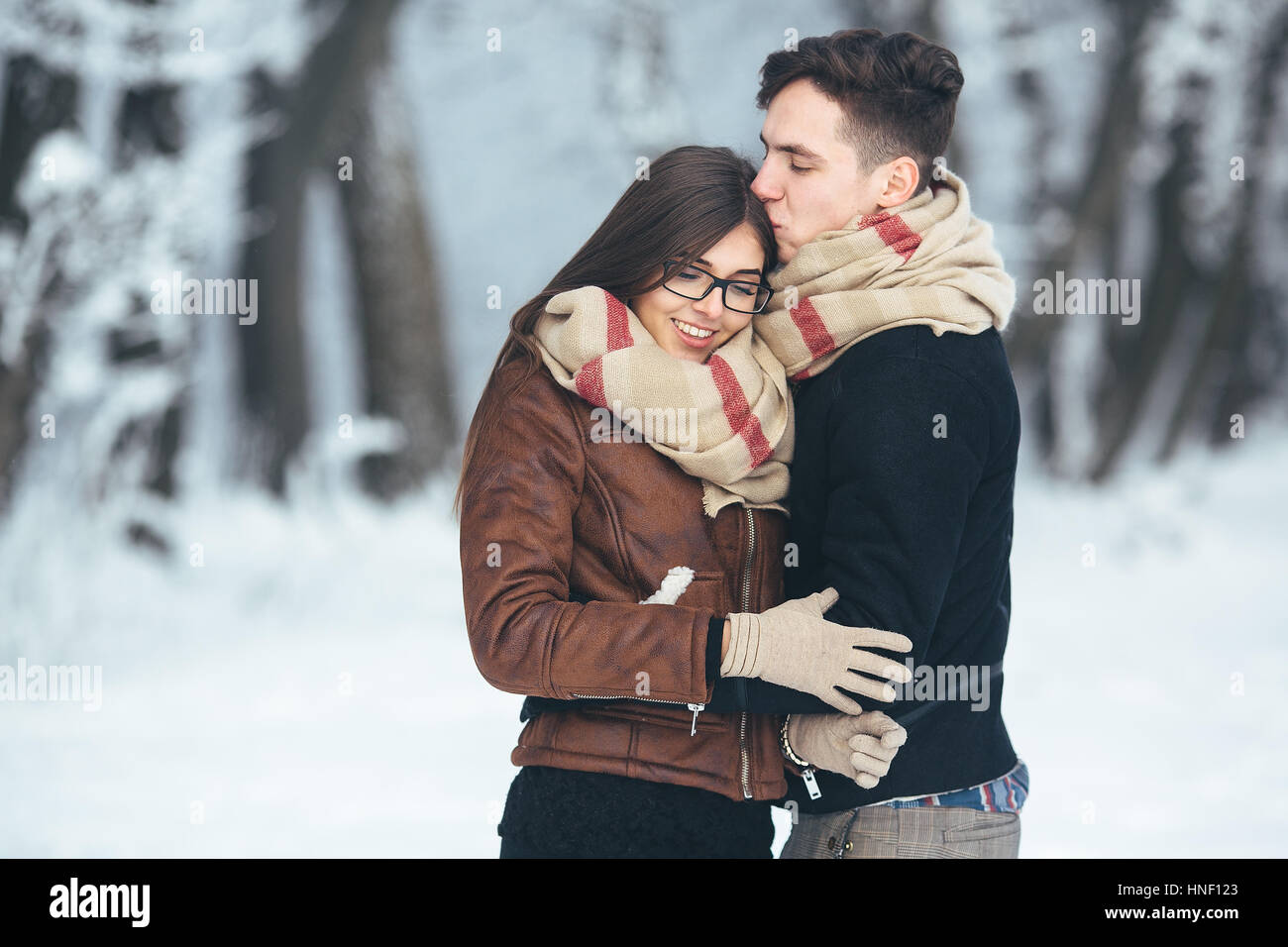 Happy couple in snow park Stock Photo - Alamy
