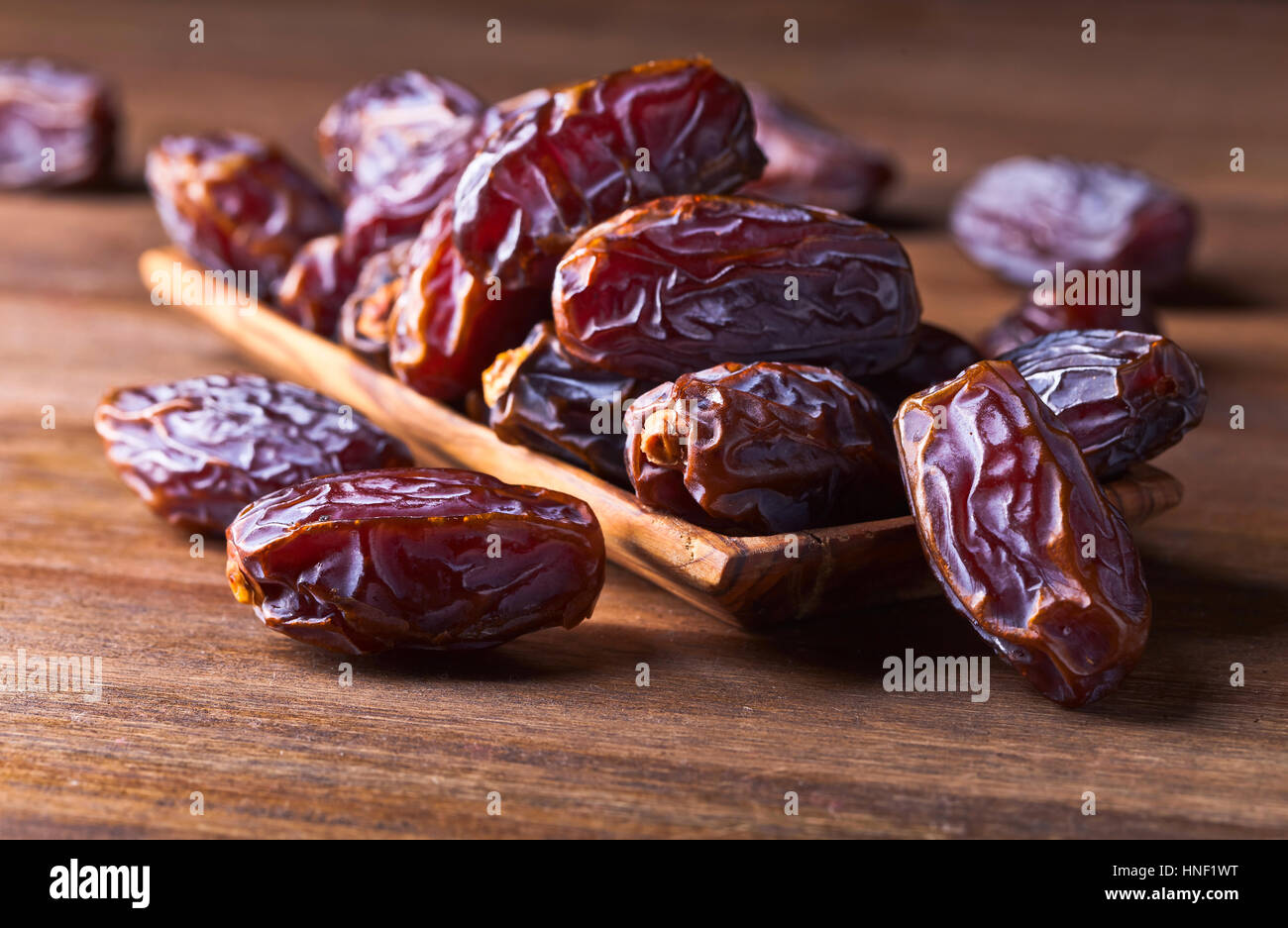 Not Fully Riped Dates juicy ripe dates on a old wooden table Stock Photo - Alamy