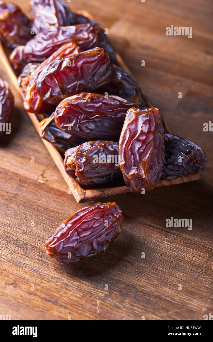 Not Fully Riped Dates juicy ripe dates on a old wooden table Stock Photo - Alamy