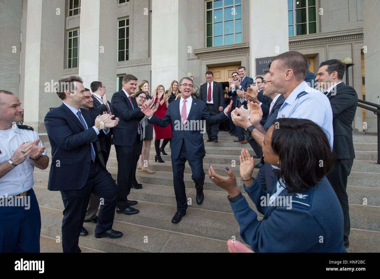 U.S. Department of Defense staff applaud as Secretary of Defense Ashton Carter leaves the Pentagon on his last day in office January 19, 2017 in Washington, DC. Stock Photo