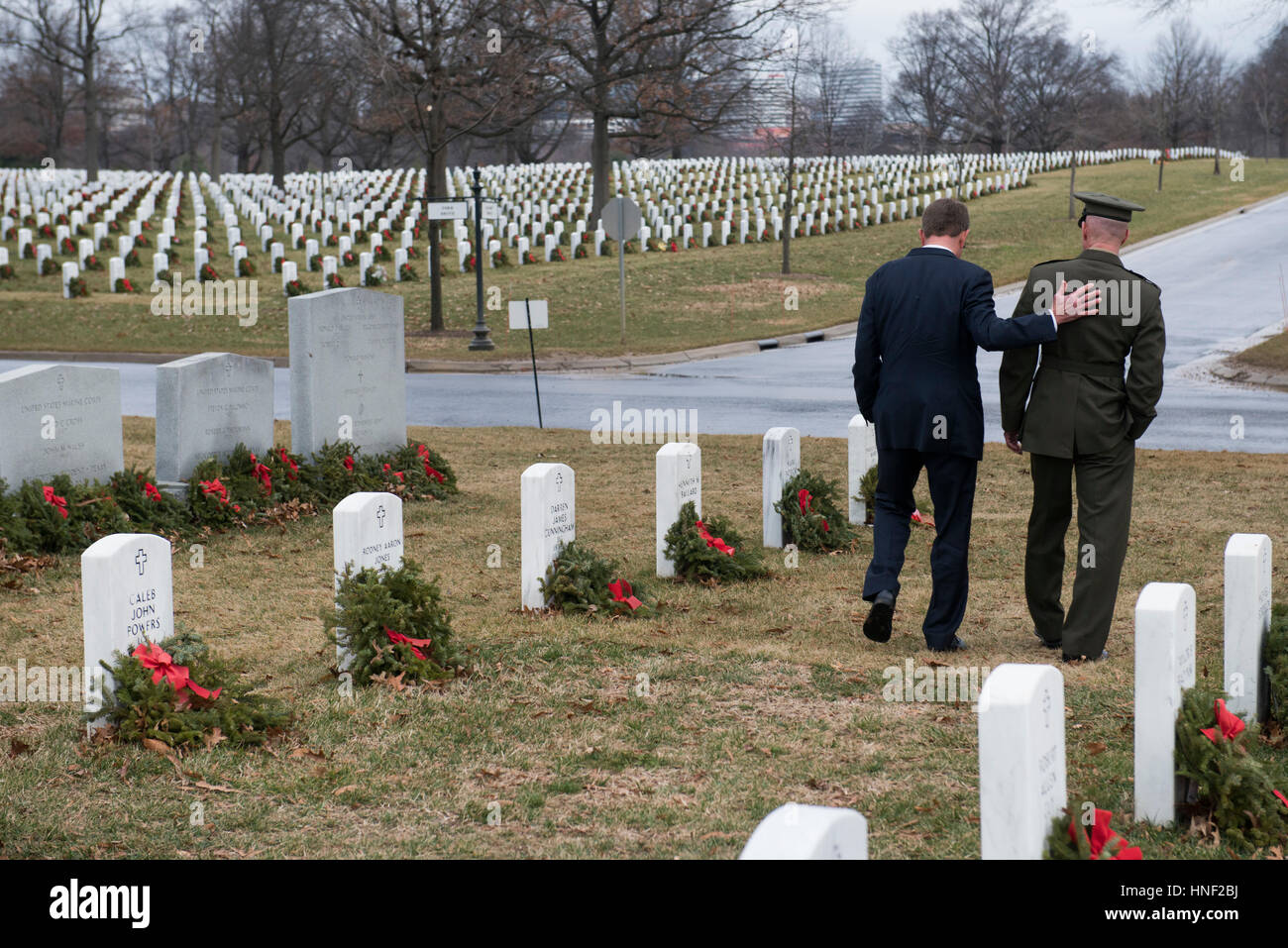 U.S. Secretary of Defense Ashton Carter and senior military aide Eric Smith visit the gravesite of fallen soldiers during his last day in office at the Arlington Cemetery January 19, 2017 in Arlington, Virginia. Stock Photo