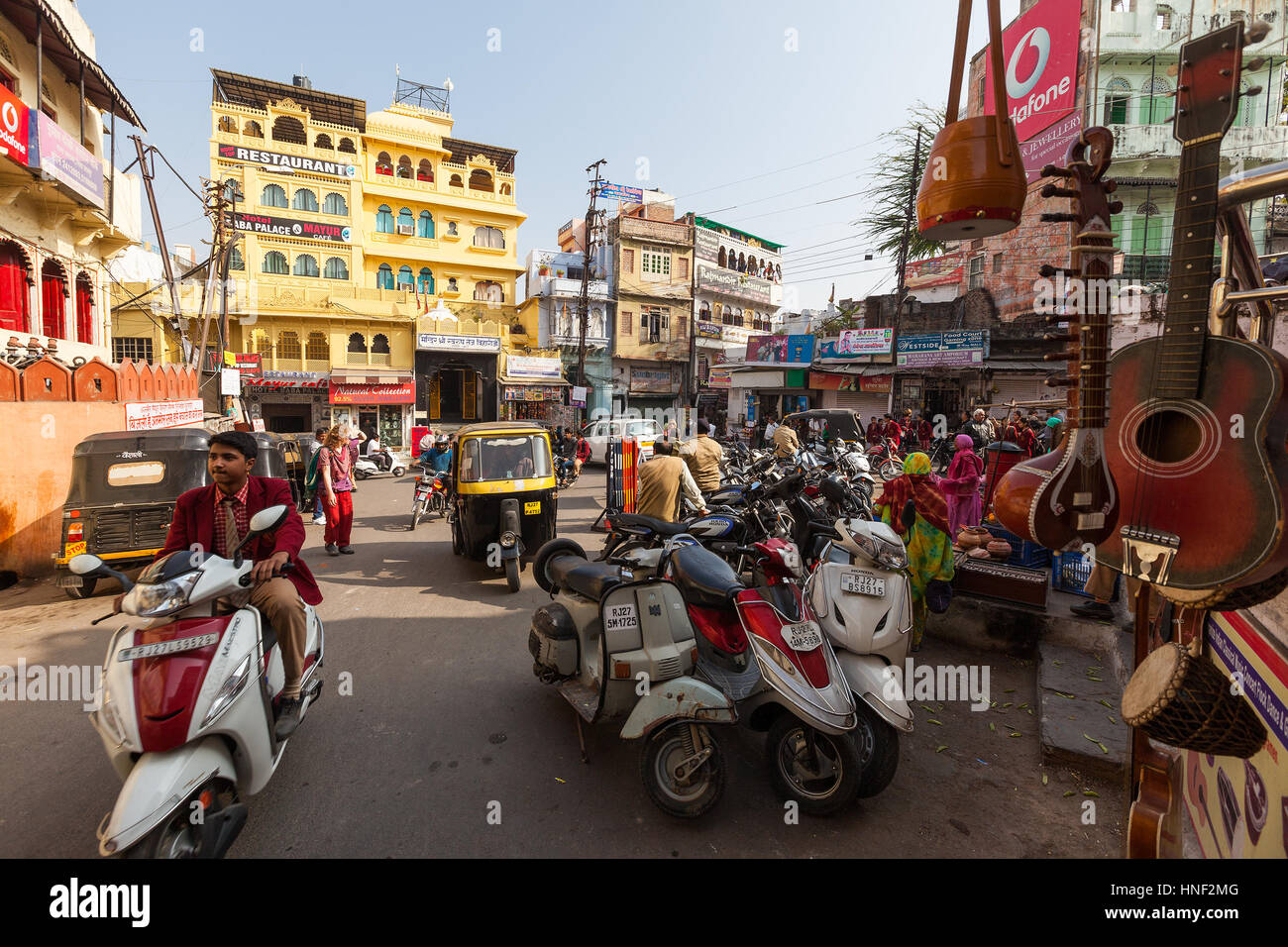 UDAIPUR, INDIA - JANUARY 16, 2015 : Busy street scene in Jagdish Chowk, a central town square in Udaipur filled with mopeds, rickshaws, locals, touris Stock Photo