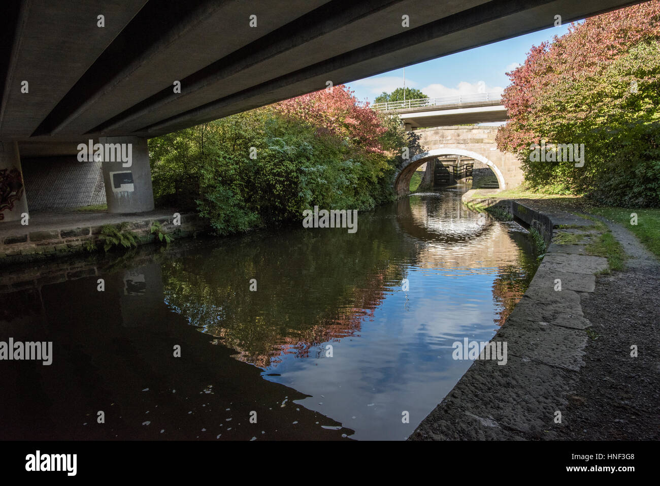 Modern concrete motorway and old stone road bridges over the Leeds Liverpool Canal at Barrowford, Lancashire Stock Photo