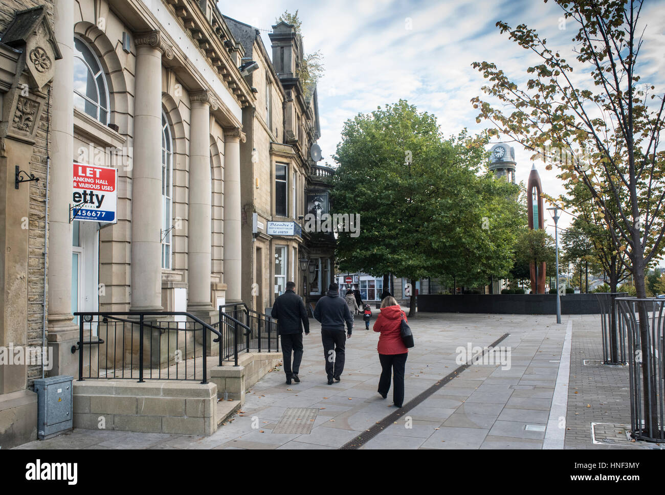 Bank building for sale in Nelson town centre, Lancashire. Also showing local cleaned sandstone buildings Stock Photo