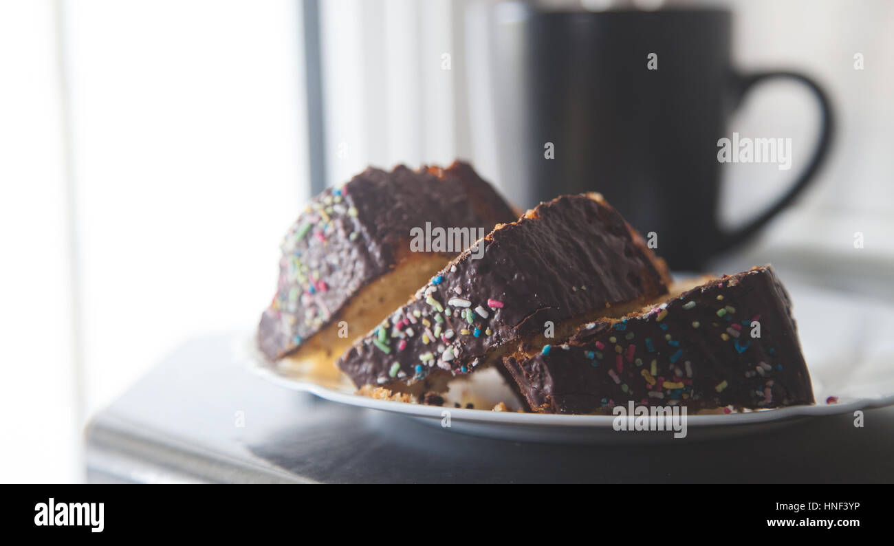 Copyspace of three slices of cake with black cup in background shot with daylight Stock Photo