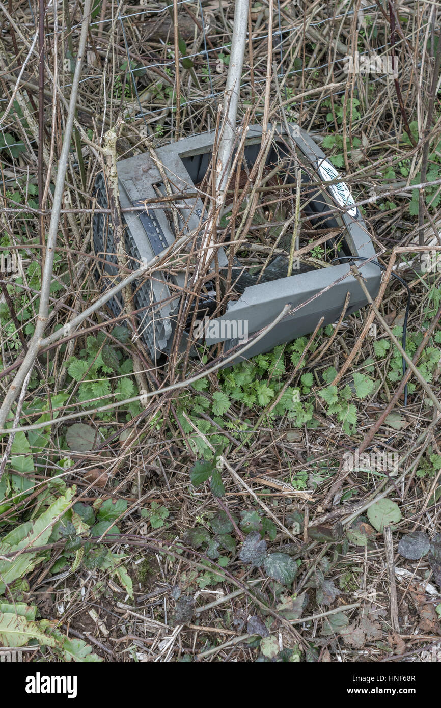 Environmental pollution in form or roadside and hedgerow rubbish discarded by the public. Fly tipping metaphor. Stock Photo