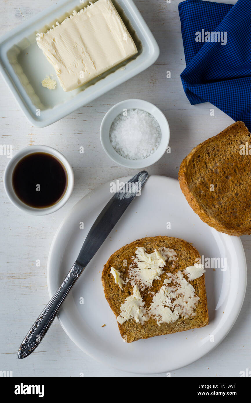 overhead shot of toast and butter breakfast with coffe on white table Stock Photo